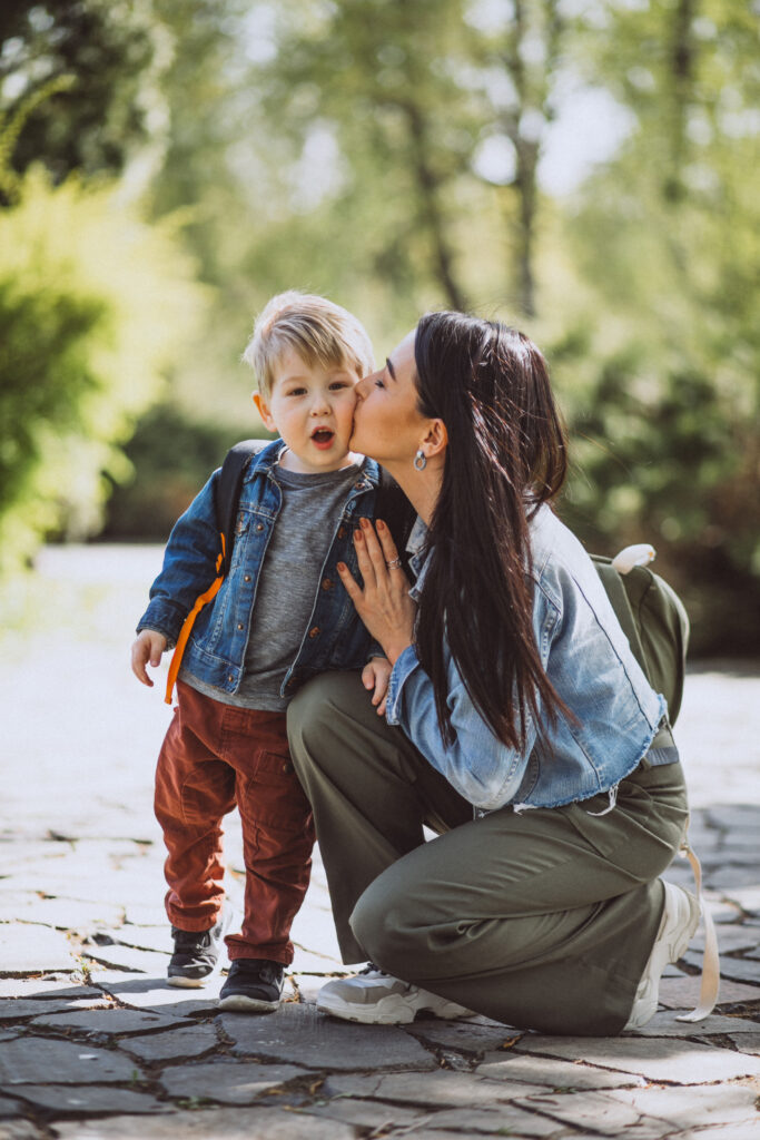 Mother with her little son having fun in park